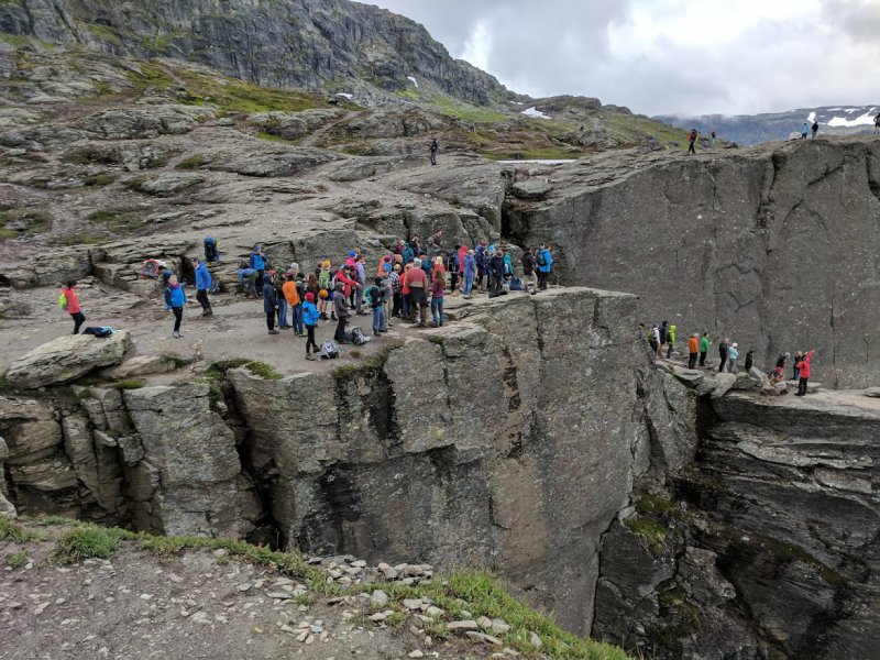 A queue of people waiting to have their photo taken on Trolltunga